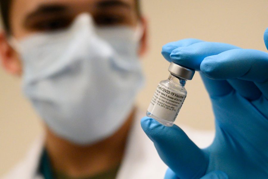 Army Spc. Angel Laureano holds a vial of the COVID-19 vaccine, Walter Reed National Military Medical Center, Bethesda, Md., Dec. 14, 2020. (DoD photo by Lisa Ferdinando)