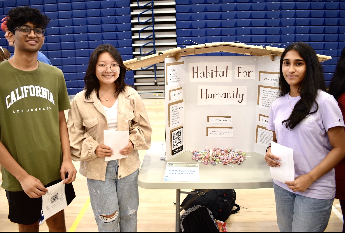 Sai Rabba, Angelina Lee and Joeanna Jilson hand out fliers and candy for their club, Habitat For Humanity.