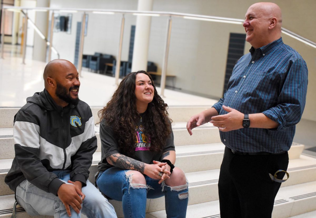 Miles Lipscomb, Brittany DelSignori talk with Jason White in between classes.  White is not only the head of the department where Lipscomb and DelSignori work, but also taught them when they were in high school.