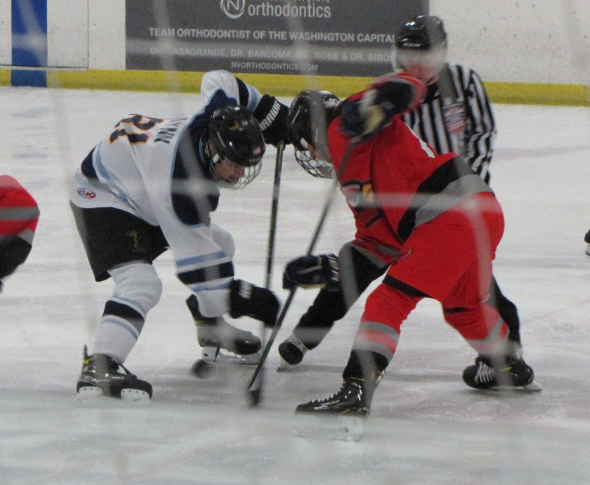 Freshman Jacob Lynn faces off against his Gainesville opponent during the hockey teams opener of the season.