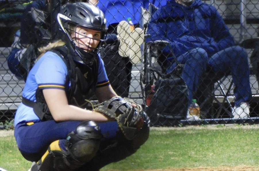 Junior Lexi Musick gets down behind home plate in the varsity softball game against Millbrook on March 11.
