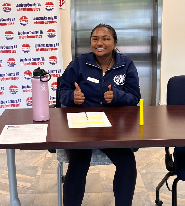 2023 graduate Anvi Chitti helps get people registered to vote.  Photo courtesy of the Loudoun County Office of Elections.