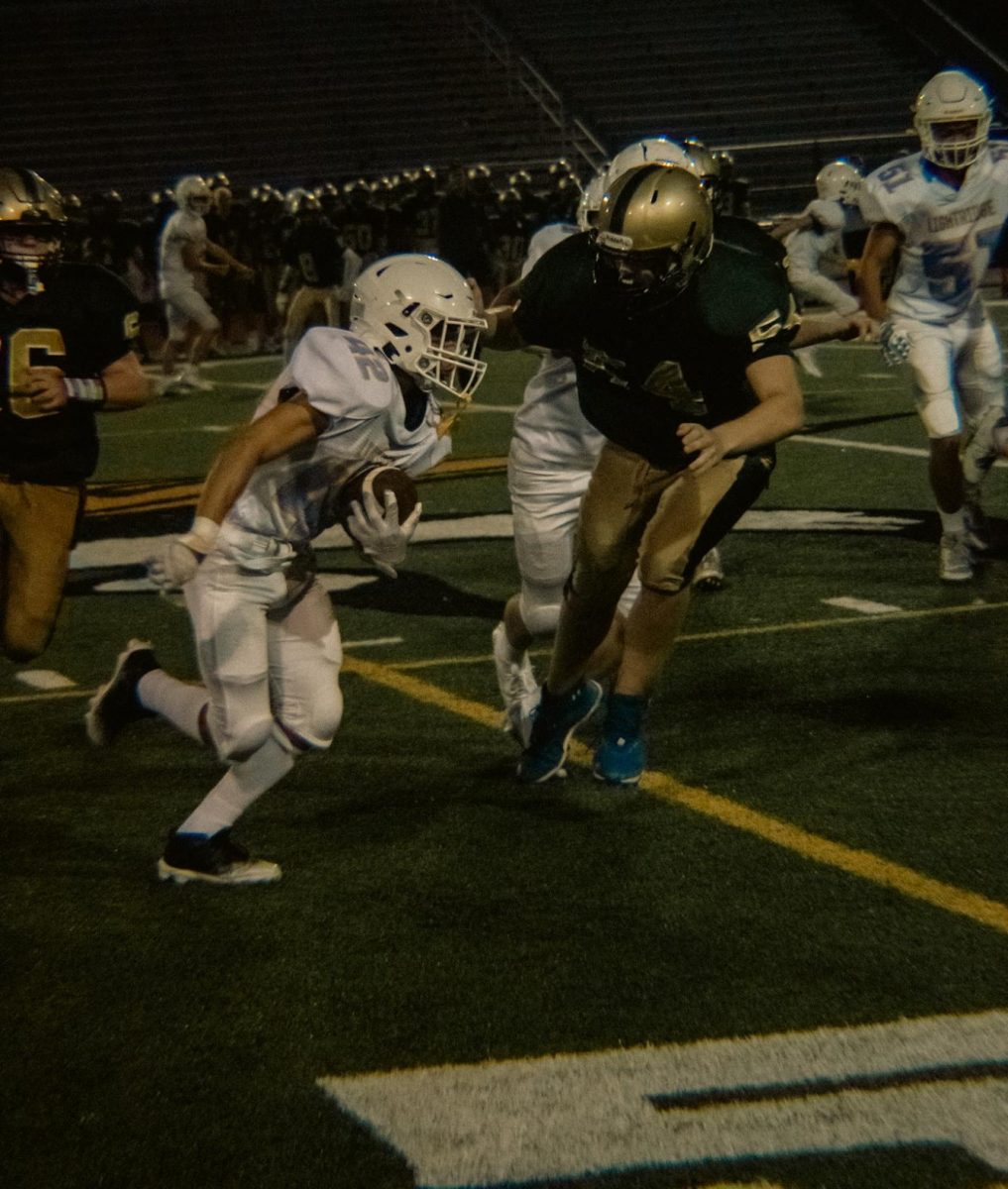 Freshman Ricardo Pena moves the ball under the lights against Langley.