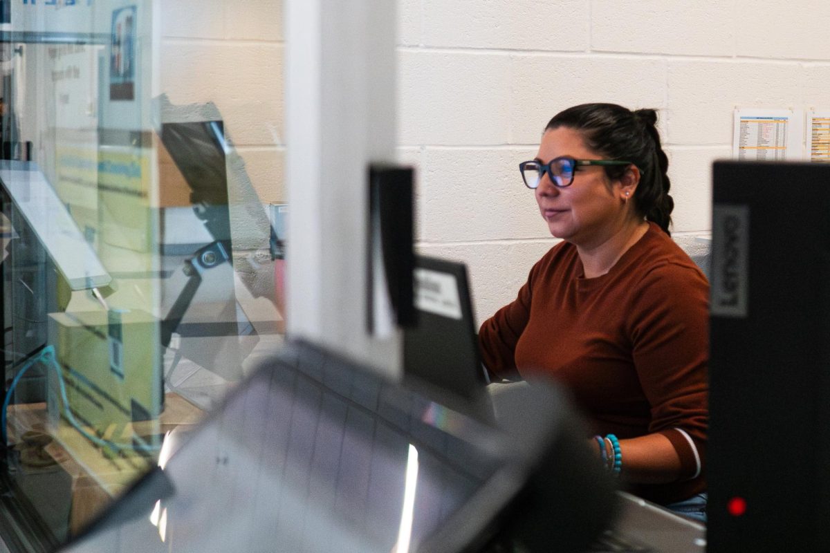 Melissa Dawson, the new Lightridge Attendance Administrative Assistant., checks students in at the beginning of the day.