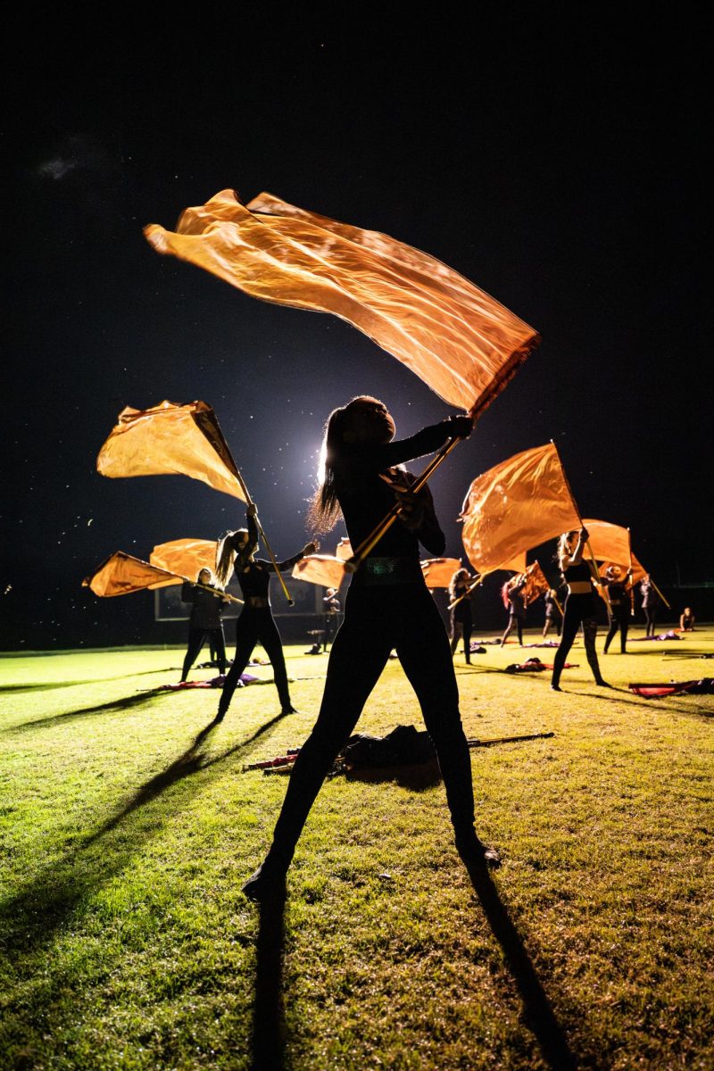 Junior Calen Owens shines during a color guard competition. Photo courtesy of the Marching Storm and Jeff Mauritzen.