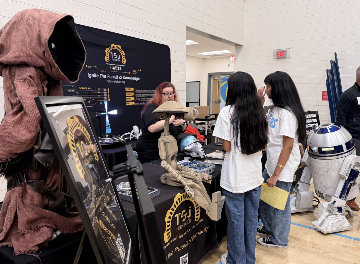Seniors talk to a representative from the TSJ Foundation, an organization devoted to fostering innovative approaches to science, technology, engineering, art and mathematics education as part of the third annual senior career fair.  Photo courtesy of Lightridge Yearbook.