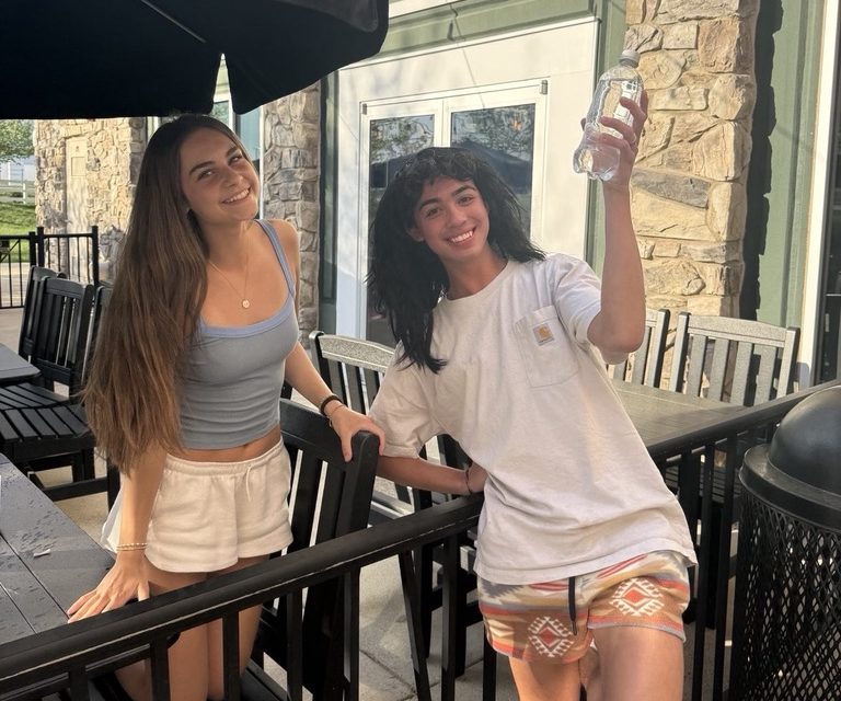 Even after Cooper Gaull's ambush attack ruined her lunch,  Reese Ayoub was still happy enough to pose for a photo with the "Wigged Assassin."  Gaull was later taken out while still wearing his wig.